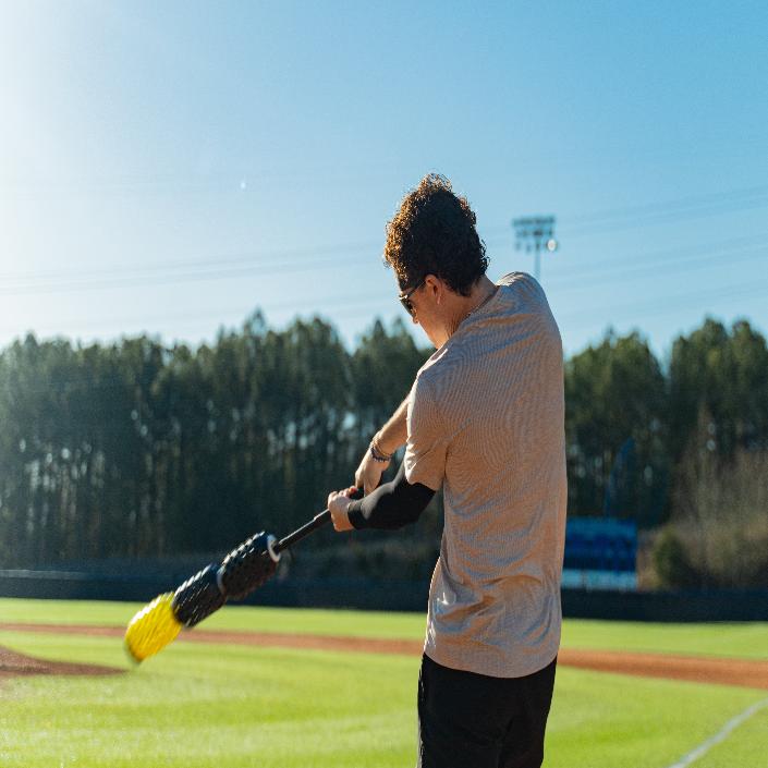Aero-Bat swing speed trainer for baseball and softball used as an on-deck warm-up device